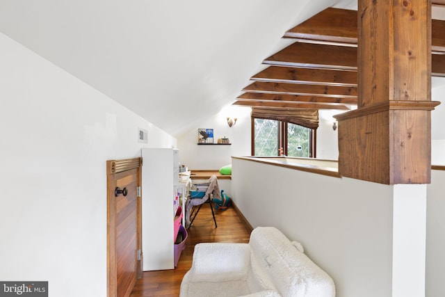 sitting room with visible vents, lofted ceiling, and wood finished floors