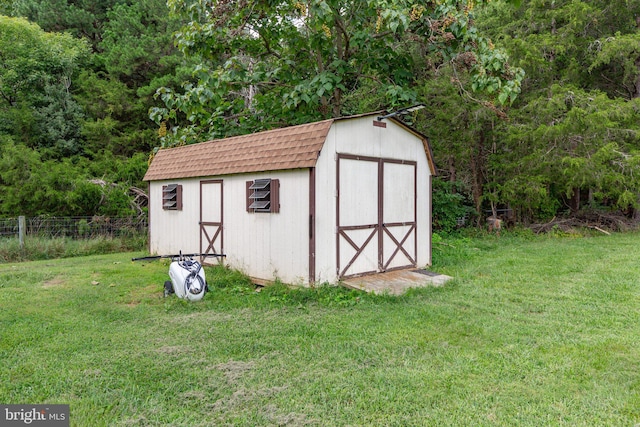 view of shed featuring fence