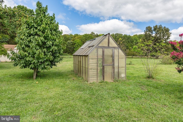 view of greenhouse featuring a lawn