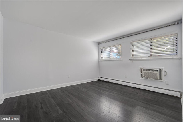 empty room featuring a baseboard heating unit, a wall unit AC, baseboards, and dark wood-style floors