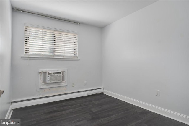 unfurnished room with dark wood-type flooring, a baseboard radiator, baseboards, and a wall mounted AC