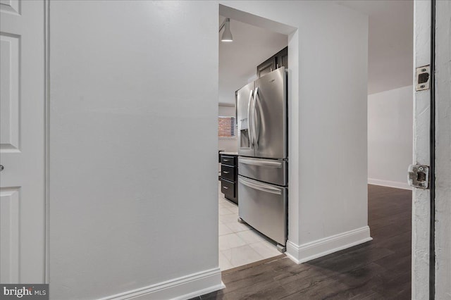 kitchen with light wood-type flooring and stainless steel fridge