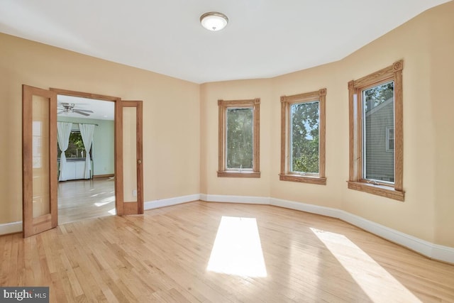 empty room featuring ceiling fan and light wood-type flooring