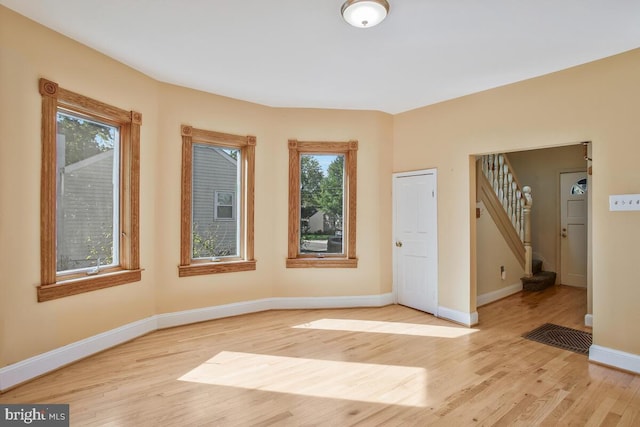 unfurnished room featuring light wood-type flooring