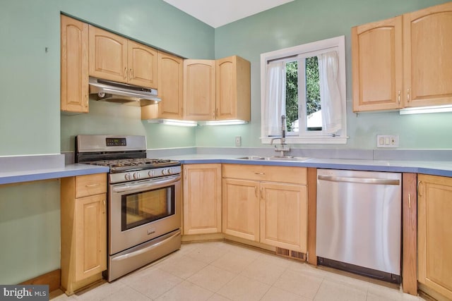 kitchen featuring appliances with stainless steel finishes, sink, and light brown cabinets