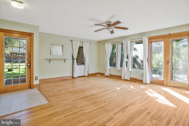 interior space featuring light hardwood / wood-style flooring, a healthy amount of sunlight, and ceiling fan