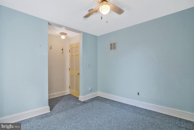 empty room featuring ceiling fan and dark colored carpet