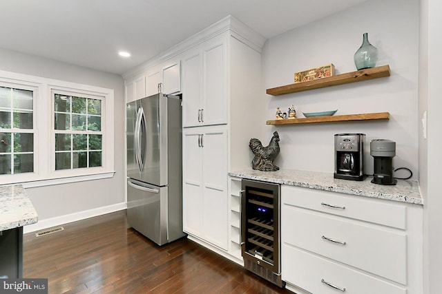 kitchen featuring stainless steel fridge, white cabinetry, dark wood-type flooring, wine cooler, and light stone countertops