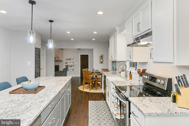 kitchen with white cabinets, decorative light fixtures, dark wood-type flooring, electric stove, and light stone countertops