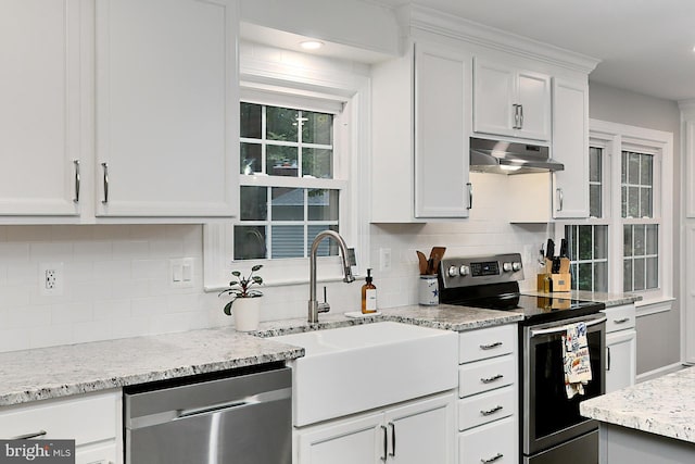 kitchen with tasteful backsplash, sink, stainless steel appliances, and white cabinets