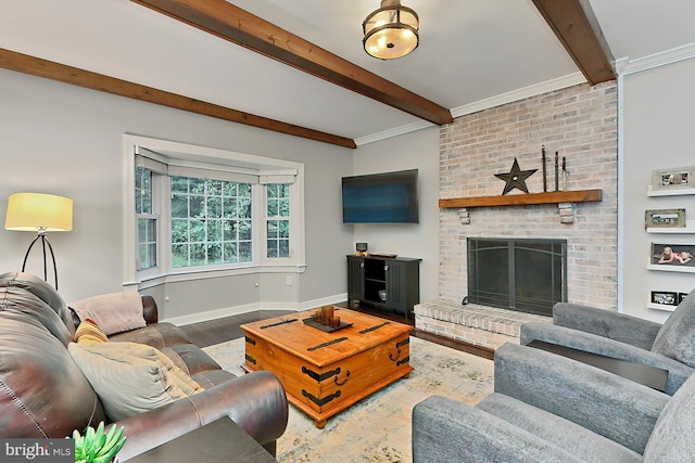 living room featuring wood-type flooring, beamed ceiling, a fireplace, and ornamental molding