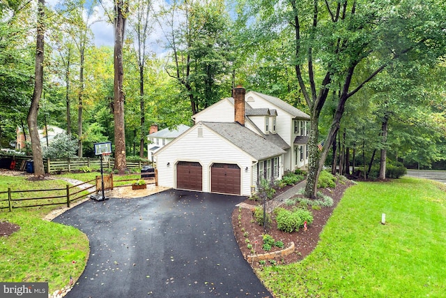 view of front of home with a front yard and a garage