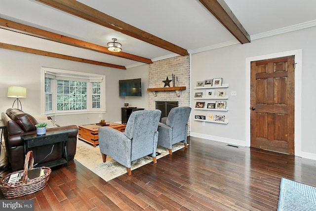 living room with ornamental molding, beamed ceiling, a fireplace, and dark hardwood / wood-style flooring