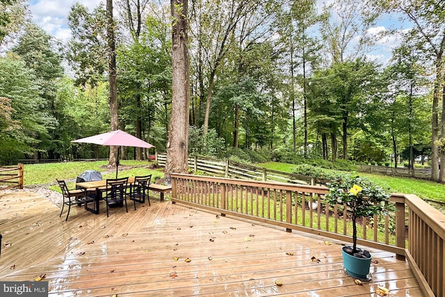 wooden deck featuring a yard