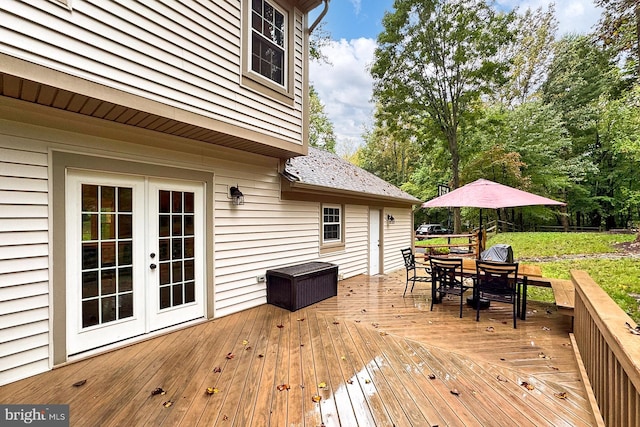 deck with a lawn and french doors