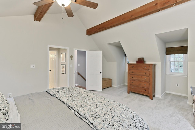 bedroom featuring vaulted ceiling with beams, ceiling fan, and light colored carpet