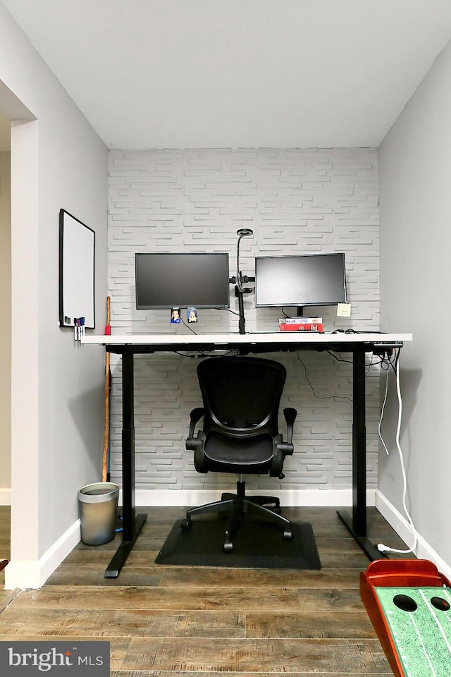 office with built in desk and hardwood / wood-style floors