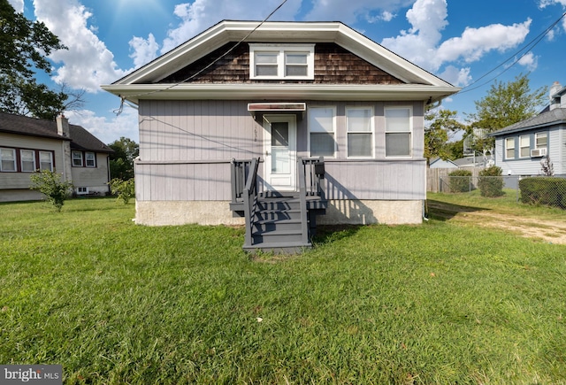 bungalow-style home with a front yard