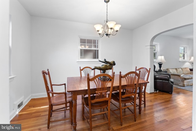 dining room featuring hardwood / wood-style flooring and a chandelier