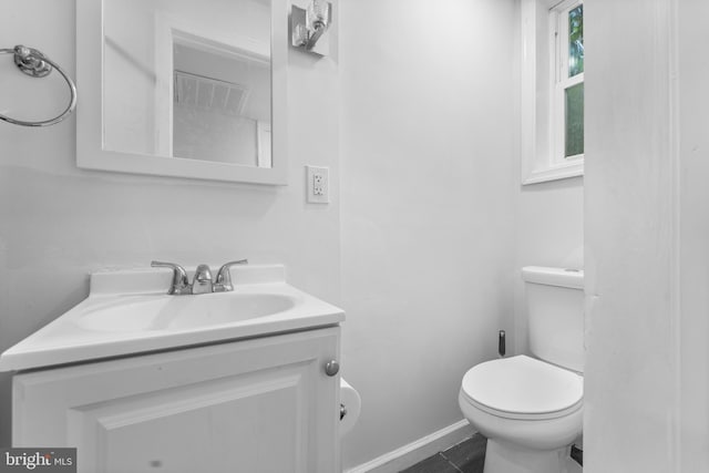 bathroom with tile patterned flooring, vanity, and toilet