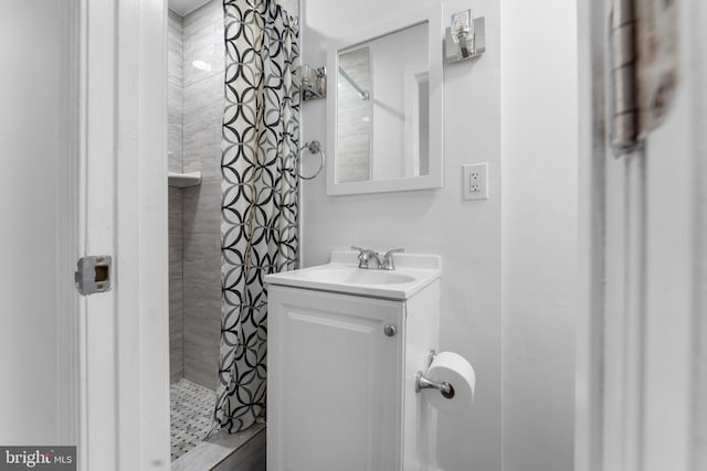 bathroom featuring vanity and a tile shower