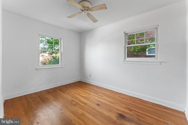 empty room with wood-type flooring and ceiling fan