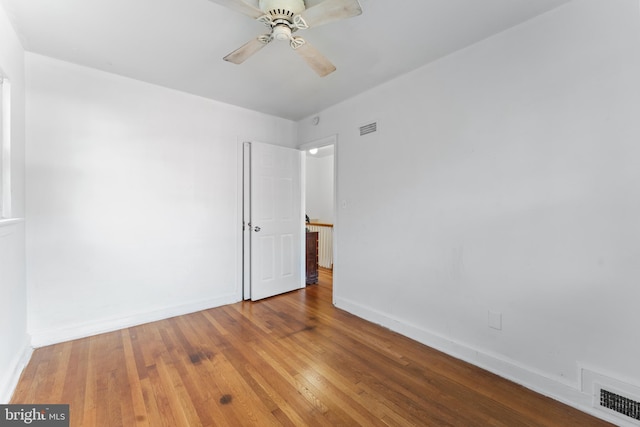 unfurnished room featuring hardwood / wood-style floors and ceiling fan