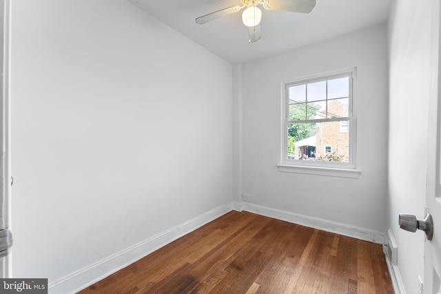 unfurnished room featuring ceiling fan and dark hardwood / wood-style flooring