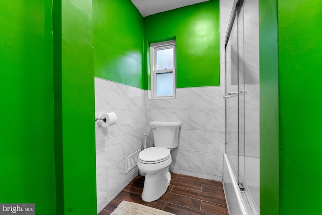 bathroom featuring tile walls, toilet, and tile patterned floors