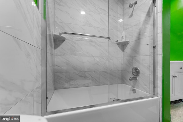 bathroom featuring shower / bath combination with glass door and vanity