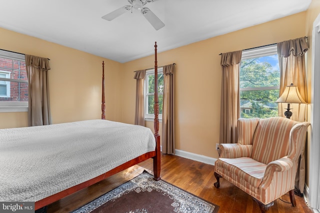 bedroom featuring multiple windows, hardwood / wood-style flooring, and ceiling fan