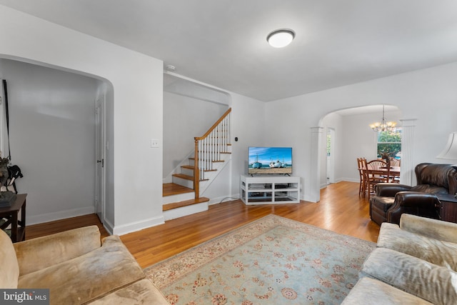 living room featuring a notable chandelier and hardwood / wood-style floors