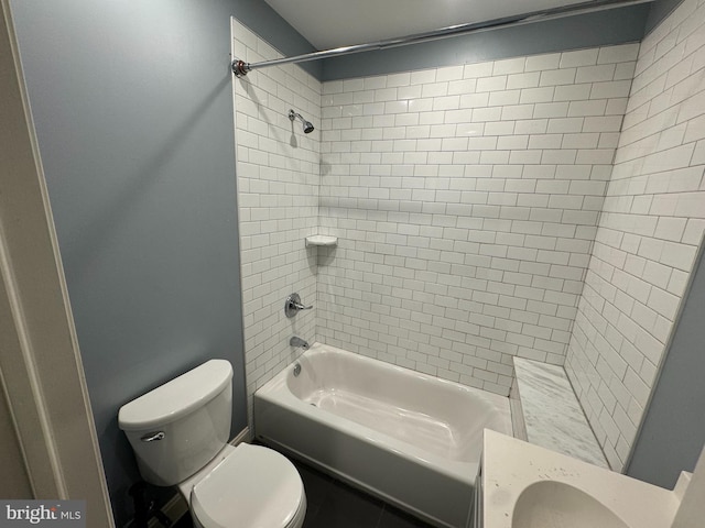 full bathroom featuring vanity, toilet, and tiled shower / bath