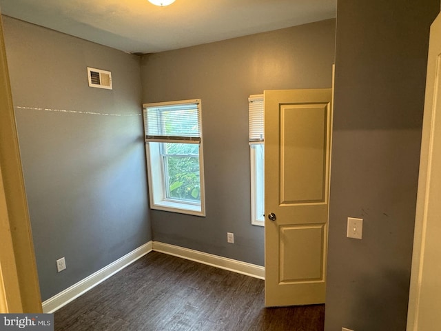 unfurnished room with dark hardwood / wood-style floors