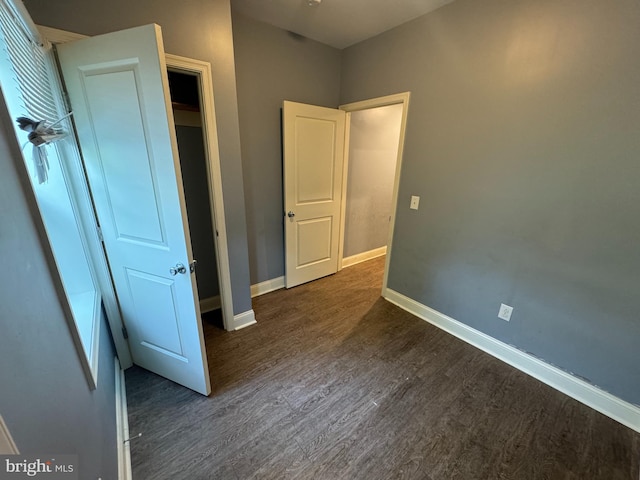 unfurnished bedroom featuring dark hardwood / wood-style flooring