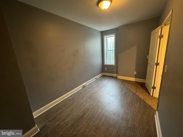 unfurnished bedroom featuring dark hardwood / wood-style flooring