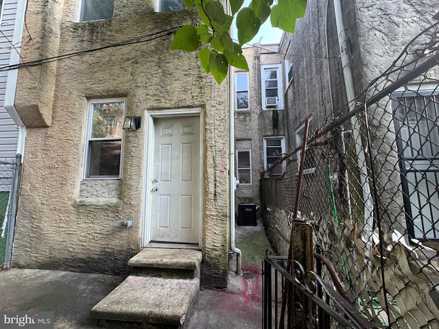 doorway to property featuring central air condition unit