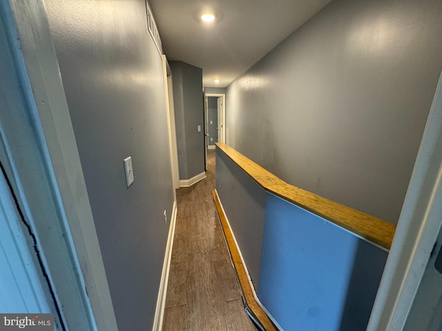 hallway with dark hardwood / wood-style flooring