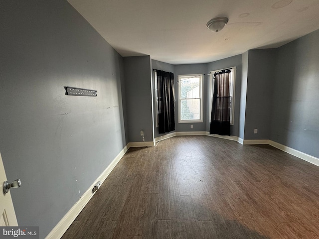 spare room featuring dark hardwood / wood-style floors