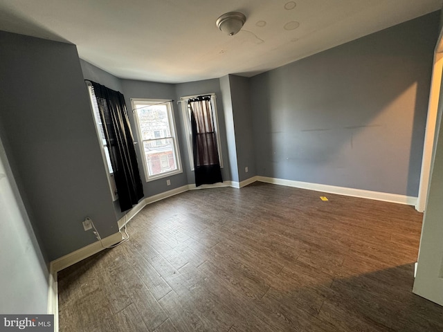 unfurnished room featuring dark hardwood / wood-style floors