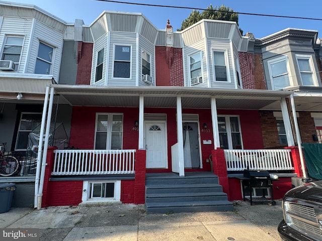 multi unit property with brick siding and covered porch