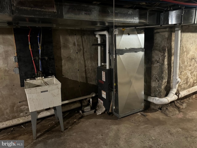 basement with heating unit and sink