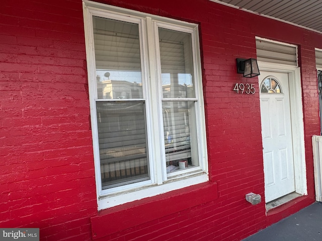 view of exterior entry featuring a porch