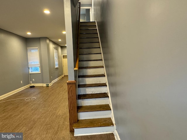 staircase with hardwood / wood-style floors