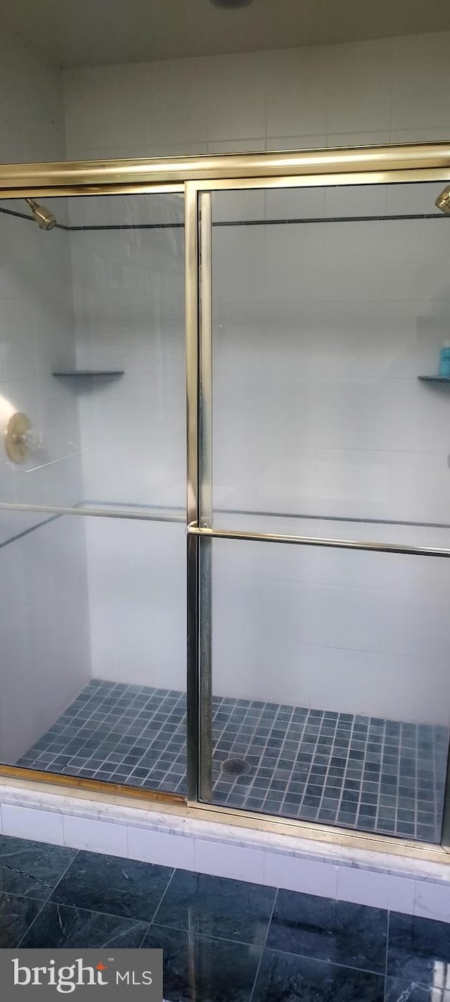 bathroom featuring an enclosed shower