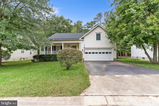 view of front of house featuring a front lawn, a garage, and covered porch