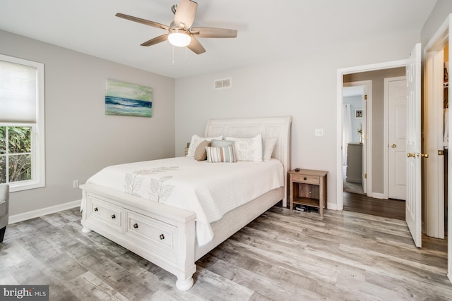 bedroom with ceiling fan and light hardwood / wood-style flooring