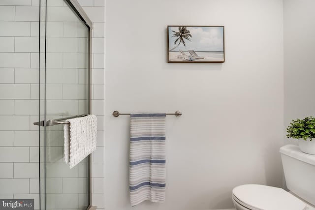 bathroom with an enclosed shower and toilet