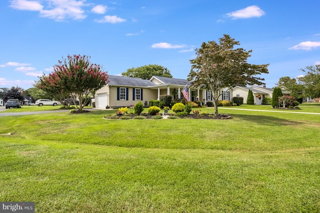 ranch-style home with a garage and a front yard