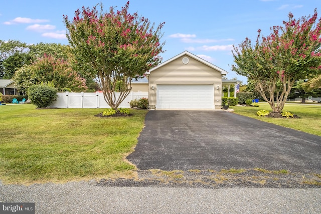 view of front of house with a front lawn and a garage